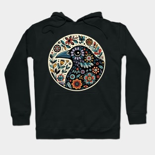 Whimsical folk art, loves crows, loves birds, crows, raven, a guardian of nature, sits among flowers, evoking a sense of protection. Hoodie